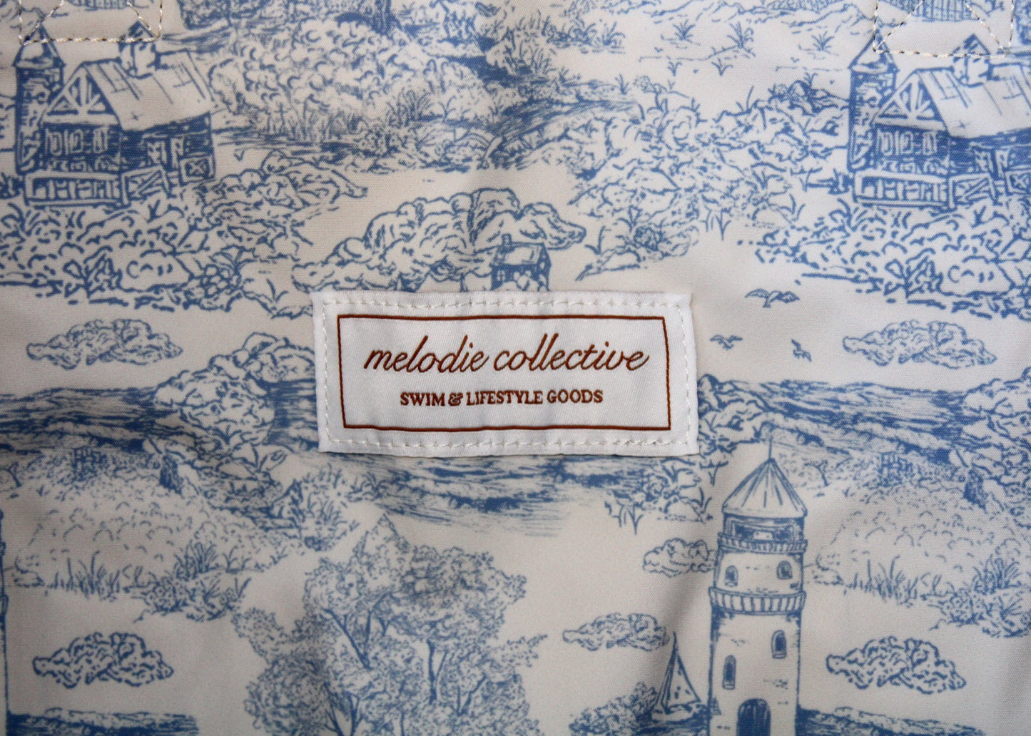 Fabric with blue and white pattern and 'melodie collective' label.