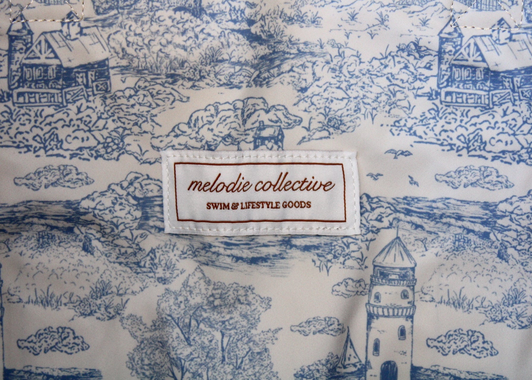 Fabric with blue and white pattern and 'melodie collective' label.