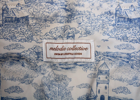Fabric with blue and white pattern and 'melodie collective' label.